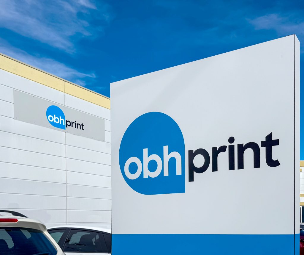 OBH Print signage closeup with back wall of building and sign.